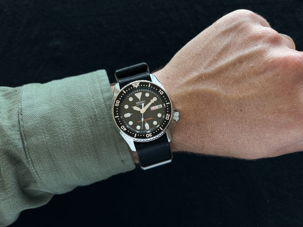 seiko skx013 dive watch on black nato on wrist